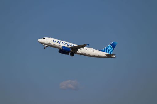 United Airlines Airbus A320 takes off from San Jose Airport with landing gear retracting.