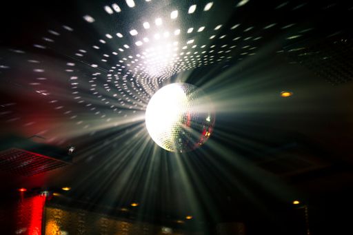 The shining disco ball hanging from the ceiling.