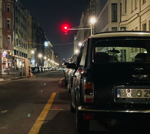 A closeup shot on the back of parked mini cooper car at night in Berlin, Germany