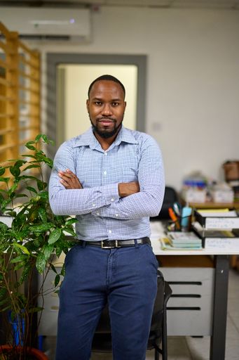 A young African American CEO standing in his office