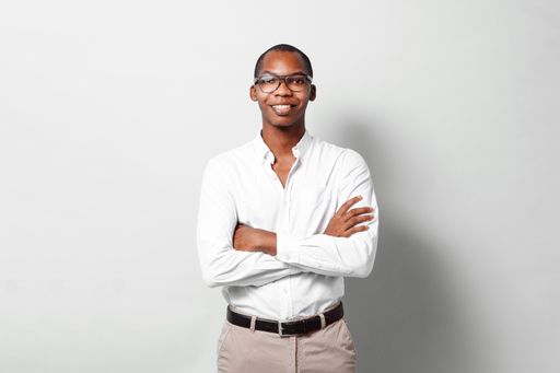 An African-American businessman in a white shirt smiling