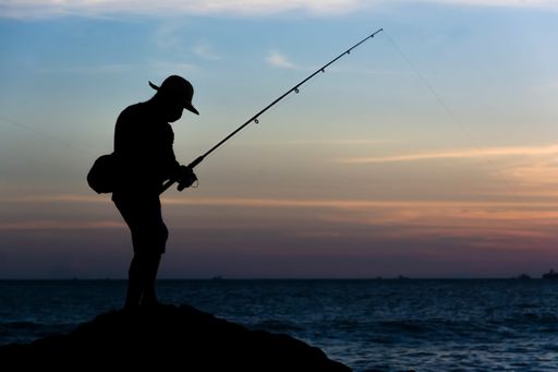 Fishermen at sunset in silhouette. Salvador, Bahia, Brazil