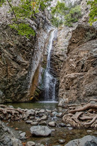 A vertical shot of a waterfall in a rocky area
