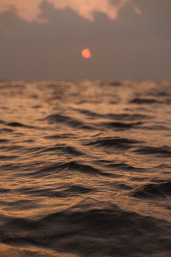 A vertical shot of the beautiful sunset above the sea. The Maldives.