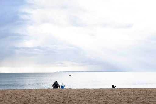 Man and his dog enjoying the beautiful scenery of Praida da Ribeira on a cloudy day.