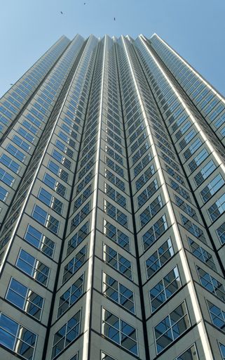 A vertical low angle shot of a modern skyscraper in the financial district in Miami, Florida, USA
