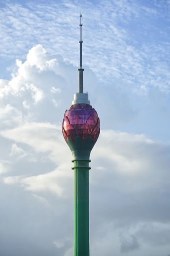 A vertical shot of a Colombo Lotus Tower under a blue cloudy sky in Sri Lanka