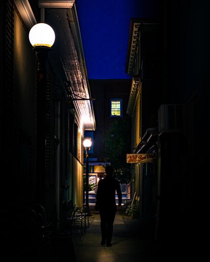 A vertical shot of a silhouette of a man in a night city, Ocean Grove, United States