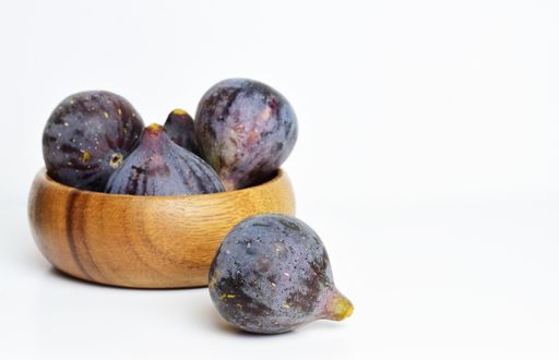 A closeup shot of ripe purple figs isolated on white background
