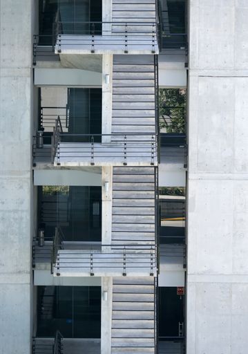 A vertical shot of a modern industrial building with emergency stairs