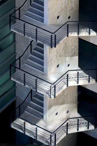 A vertical shot of a modern industrial building with emergency stairs
