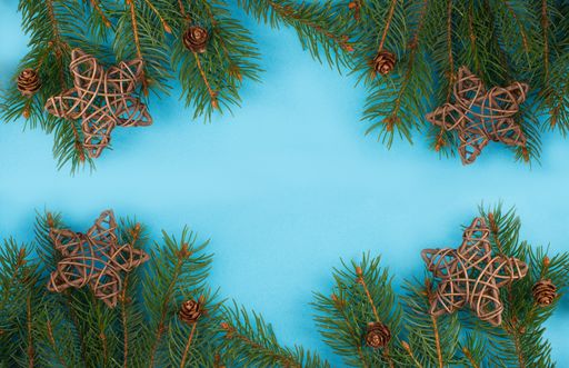 Christmas background with branches of fir, empty copy space, blue backdrop