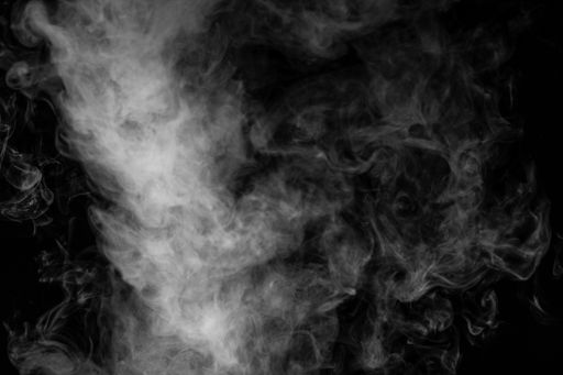 A close-up shot of a huge cloud of smoke or steam isolated on a black background