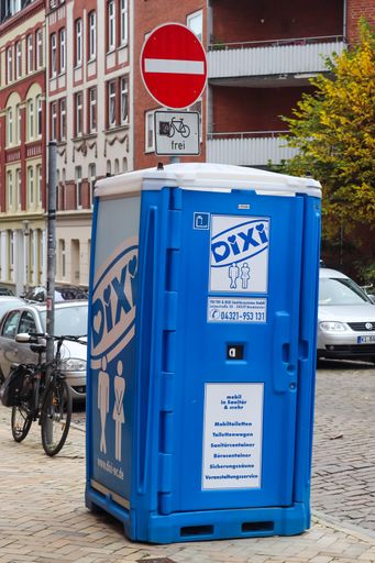 A vertical shot of a portable toilet in a blue plastic house of the company Dixi in Kiel, Germany