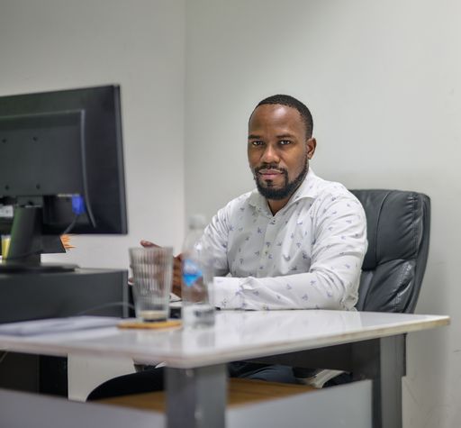 A young African American CEO working in his office