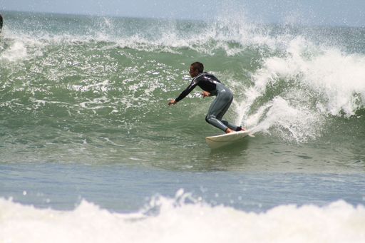A person surfing on the waves in Necochea, Argentina