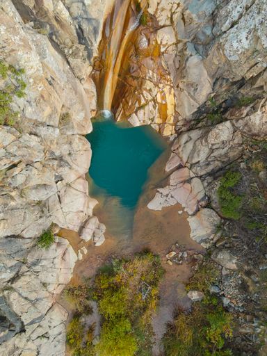 A vertical aerial shot of the waterfall of Vathylimno, near Xidira, Lesvos, Greece