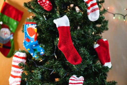 A closeup shot of a decorated Christmas tree with ornaments and stockings