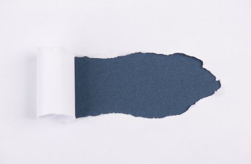 White torn paper, blue background, empty copy space for text, ripped sheet