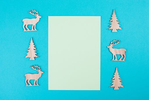 Christmas greeting card, empty copy space, blank paper, reindeer, christmas tree, blue colored background