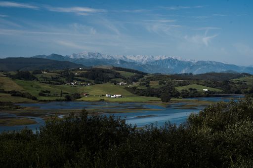 A tranquil landscape of a lakeside hills and small villages in daylight