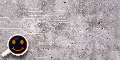 A top view of a coffee cup with a smiley face on a concrete surface for copy space