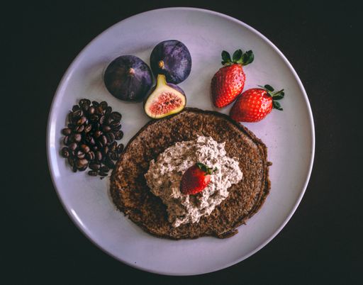 A top view of fresh ripe fruits, bread, and coffee beans