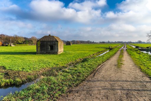 Remaining World War 2 bunkers in a December polder landscape in a polder between Utrecht and Amsterdam