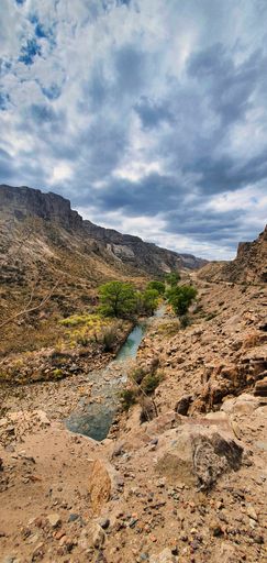 A vertical shot of the small river going through the rocks in San Rafael, Mendoza, Argentina