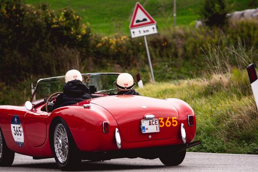 A selective focus shot of AC Ace vintage car racing in a rally in Cagli, Italy