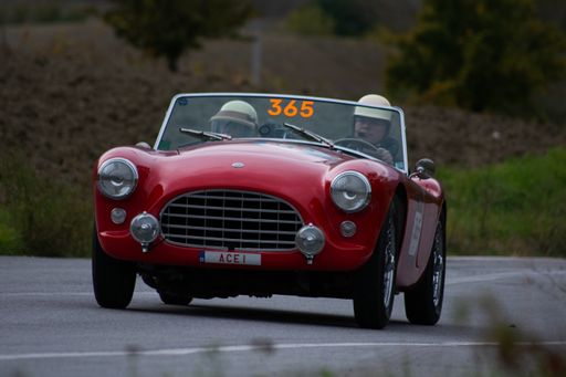 A selective focus shot of an old racing car AC Ace in rally Mille Miglia in Cagli, Italy