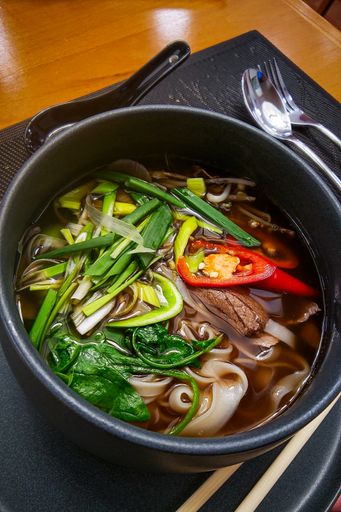 A vertical shot of a Japanese dish in a bowl on the table