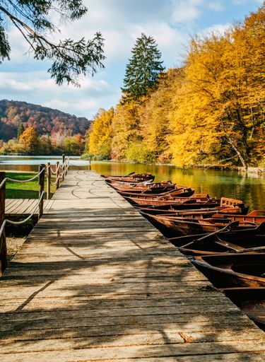 A group of paddle boats by the pier at famous Plitvice Lakes National Park in Croatia in autumn