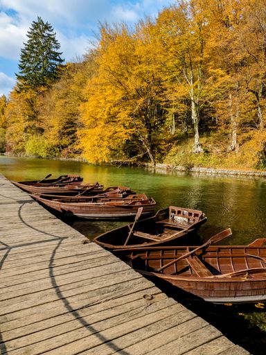 A group of paddle boats by the pier at famous Plitvice Lakes National Park in Croatia in autumn
