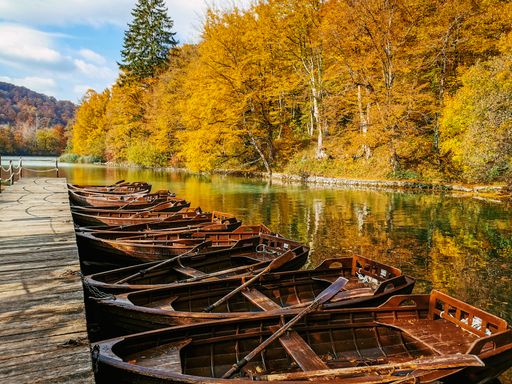 A group of paddle boats by the pier at famous Plitvice Lakes National Park in Croatia in autumn