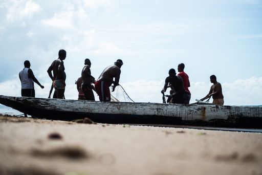 A view of Fishermen pulling the fishing net from the sea with fish inside in Salvador, Brazil