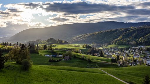 A beautiful shot of a landscape under the cloudy skies in Switzerland