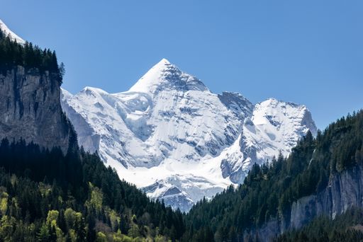A beautiful shot of a mountain covered in snow under the clear skies in Switzerland