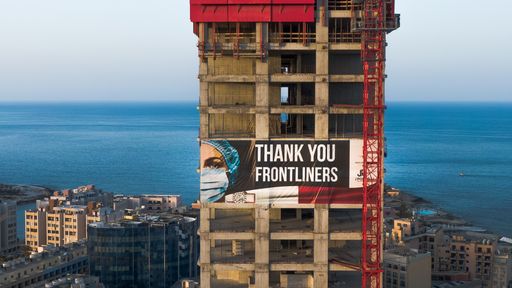 Aerial shots of High rise Tower - Pender Towers - Under construction
 with a big sign thanking the frontliners during covid-19 pandemic crisis