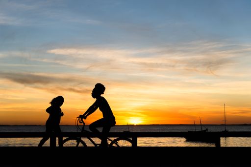 A Silhouette of people walking, running, talking and enjoying the sunset on Ribeira beach