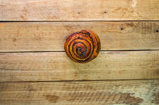 A top view of fresh cinnamon on a wooden table with copy space