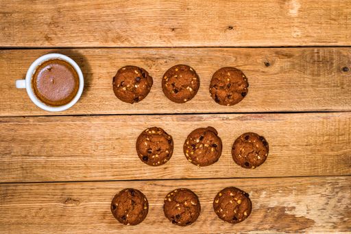 The fresh biscuits are on a wooden table. Coffee, food, and breakfast concept. Desserts, fresh pastries and coffee. Top view and copy space