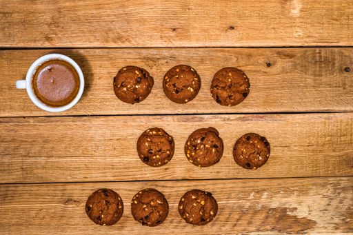 The fresh biscuits are on a wooden table. Coffee, food, and breakfast concept. Desserts, fresh pastries, and coffee. Top view and copy space
