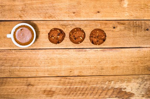The fresh biscuits are on a wooden table. Coffee, food, and breakfast concept.
