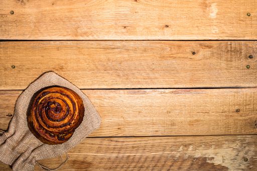 A closeup shot of a sweet and fresh puff on a wooden table surface
