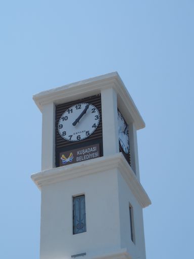 A vertical low angle shot of a tower with the clock in Kusadasi, Turkey