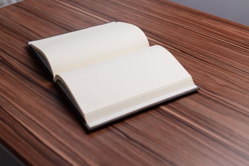 A beautiful shot of an opened notebook on the wooden desk