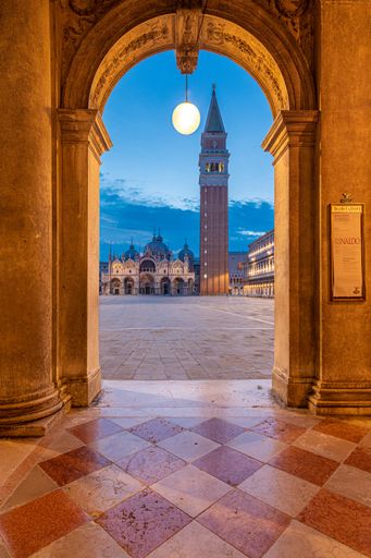 A vertical shot of the magical and beautiful cityscape of Venice, Italy during an evening