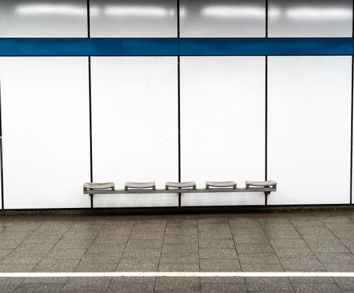 Empty seats in the Munich subway station. Urban underground concept without people. Seating for rest and relaxation in modern station.