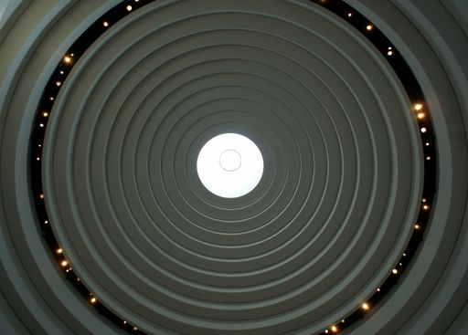 A low angle shot of a circular abstract roof
